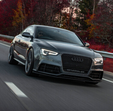 Black Audi Car Driving On A Road